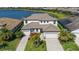 Beautiful two-story home with tile roof, attached two-car garage, mature landscaping, and water view at 6410 Rosehill Farm Run, Bradenton, FL 34211