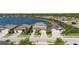 An aerial view of a beautiful two-story home with a tile roof, landscaping and lake view at 6410 Rosehill Farm Run, Bradenton, FL 34211