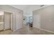 Neutral hallway featuring tile floors, closet storage, and access to various rooms in the home at 6410 Rosehill Farm Run, Bradenton, FL 34211