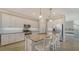 Bright kitchen featuring stainless steel appliances, island with granite countertop, and breakfast bar seating at 6410 Rosehill Farm Run, Bradenton, FL 34211