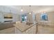 Gourmet kitchen featuring stainless steel appliances, island with granite countertop, and open floor plan at 6410 Rosehill Farm Run, Bradenton, FL 34211