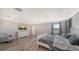 A large main bedroom features hardwood floors, a ceiling fan, and a charming rocking chair at 6410 Rosehill Farm Run, Bradenton, FL 34211