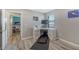 A home office with gray walls and wood floors includes an exercise treadmill and a storage closet at 6410 Rosehill Farm Run, Bradenton, FL 34211