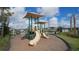Community playground with slides and shade covers, providing a fun and safe play area for children with lush, green landscaping at 6410 Rosehill Farm Run, Bradenton, FL 34211