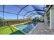 Inviting screened pool area with well-maintained landscaping, perfect for relaxing and enjoying outdoor activities at 6410 Rosehill Farm Run, Bradenton, FL 34211