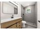 Bathroom featuring a modern vanity, updated shower, and black fixtures at 6639 16Th N St, St Petersburg, FL 33702