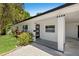 Close up of the front of the modern single-story home featuring a covered carport and well-maintained landscaping at 6639 16Th N St, St Petersburg, FL 33702
