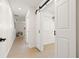 Hallway featuring a sliding closet door and plenty of natural light from a window at the end at 6639 16Th N St, St Petersburg, FL 33702