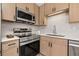 Close up of modern kitchen featuring stainless steel appliances, and sleek wood-tone cabinetry at 6639 16Th N St, St Petersburg, FL 33702