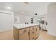 Modern kitchen island with white countertops and stylish wood-tone cabinets with black hardware at 6639 16Th N St, St Petersburg, FL 33702