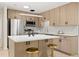 Modern kitchen featuring stainless steel appliances, an island, and sleek wood-tone cabinetry at 6639 16Th N St, St Petersburg, FL 33702