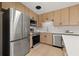Modern kitchen featuring stainless steel appliances, an island, and sleek wood-tone cabinetry at 6639 16Th N St, St Petersburg, FL 33702