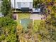 Overhead view showing the property and surrounding mature trees, along with outdoor living spaces at 6811 6Th W St, Bradenton, FL 34207
