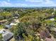 A panoramic view of a house and neighborhood, with lush greenery reaching towards a distant ocean horizon at 6811 6Th W St, Bradenton, FL 34207