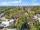 Expansive aerial perspective highlighting a home in a community near the water, surrounded by mature trees at 6811 6Th W St, Bradenton, FL 34207
