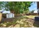 Backyard of log home including a shed and a pergola with a garden and trees at 6811 6Th W St, Bradenton, FL 34207