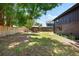 Log home showing the backyard with a pergola with chairs and flowers at 6811 6Th W St, Bradenton, FL 34207
