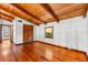 Bedroom with wood floors and wood beamed ceiling, window and closet at 6811 6Th W St, Bradenton, FL 34207