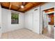 Comfortable bedroom features tile flooring, natural wood beam ceilings, and a closet at 6811 6Th W St, Bradenton, FL 34207