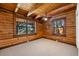 Warm bedroom featuring carpet flooring and natural wood walls and ceilings at 6811 6Th W St, Bradenton, FL 34207