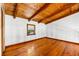 Bright bedroom featuring wood floors, beamed ceilings, and a window for natural light at 6811 6Th W St, Bradenton, FL 34207