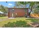 Exterior elevation showing back of the log sided home and landscaped backyard at 6811 6Th W St, Bradenton, FL 34207