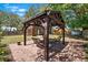 Gazebo on a paver patio features patio furniture and manicured landscaping at 6811 6Th W St, Bradenton, FL 34207
