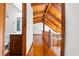 Hallway with wood floors and wood ceiling beams, leading to a bathroom and other rooms in the home at 6811 6Th W St, Bradenton, FL 34207