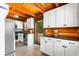 Charming kitchen features stainless steel appliances, black counters and white cabinets, with wood-beam ceilings at 6811 6Th W St, Bradenton, FL 34207