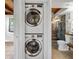 Functional laundry room features a stacked washer and dryer next to the bathroom at 6811 6Th W St, Bradenton, FL 34207
