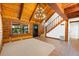 The cozy living room has a log cabin design, a chandelier, and stairs leading to the second floor at 6811 6Th W St, Bradenton, FL 34207