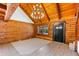 Cozy living room with natural wood walls, tiled floors and stylish chandelier at 6811 6Th W St, Bradenton, FL 34207
