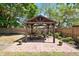 Pergola with patio furniture with flower pots sitting on a paved surface in a backyard at 6811 6Th W St, Bradenton, FL 34207