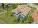 Aerial view of the house and pool screened in with a brick roof at 6915 Honeysuckle Trl, Lakewood Ranch, FL 34202