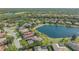 Aerial view of neighborhood home with a tile roof on a beautiful lake at 6915 Honeysuckle Trl, Lakewood Ranch, FL 34202