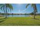 Grassy backyard with a view of a beautiful blue lake at 6915 Honeysuckle Trl, Lakewood Ranch, FL 34202