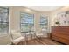Cozy bedroom sitting area showcases tranquil views, hardwood floors, and natural light at 6915 Honeysuckle Trl, Lakewood Ranch, FL 34202