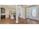 Elegant dining room featuring decorative pillars, wood floors, and an ornate chandelier at 6915 Honeysuckle Trl, Lakewood Ranch, FL 34202