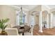 Elegant dining room featuring decorative pillars, wood floors, and a large window at 6915 Honeysuckle Trl, Lakewood Ranch, FL 34202