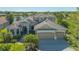 Elegant home features a tile roof, three-car garage and a well manicured lawn at 6915 Honeysuckle Trl, Lakewood Ranch, FL 34202