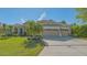 Beautifully landscaped home with a well manicured lawn and a three-car garage at 6915 Honeysuckle Trl, Lakewood Ranch, FL 34202