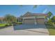 Beautifully landscaped home with a well manicured lawn and a three-car garage at 6915 Honeysuckle Trl, Lakewood Ranch, FL 34202