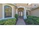 Welcoming entryway with a brick path leading to the decorative glass double doors at 6915 Honeysuckle Trl, Lakewood Ranch, FL 34202
