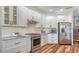 Modern kitchen with white cabinetry, stainless steel appliances, and plenty of counter space at 6915 Honeysuckle Trl, Lakewood Ranch, FL 34202