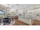 Open-concept kitchen with stainless steel appliances, granite countertops, and a large island with views of the living area at 6915 Honeysuckle Trl, Lakewood Ranch, FL 34202