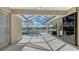 Screened lanai with a heated pool and views of a serene lake, providing a perfect outdoor retreat at 6915 Honeysuckle Trl, Lakewood Ranch, FL 34202