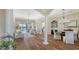 Spacious living room showcasing wood floors, lake views, and access to dining area at 6915 Honeysuckle Trl, Lakewood Ranch, FL 34202