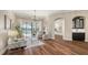 Bright living room featuring hardwood floors, modern chandelier, wet bar and glass sliding doors to the pool at 6915 Honeysuckle Trl, Lakewood Ranch, FL 34202