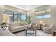 Bright living room boasts comfortable seating and a view of the pool area at 6915 Honeysuckle Trl, Lakewood Ranch, FL 34202