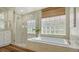 Luxurious bathroom showcases soaking tub, glass shower, and natural light at 6915 Honeysuckle Trl, Lakewood Ranch, FL 34202